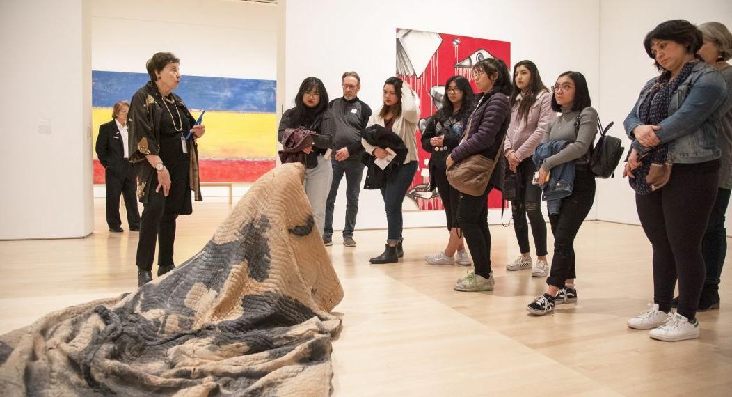 students look at artwork during a Humanities trip to SF MOMA