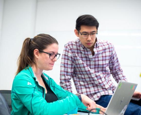 students looking at laptop