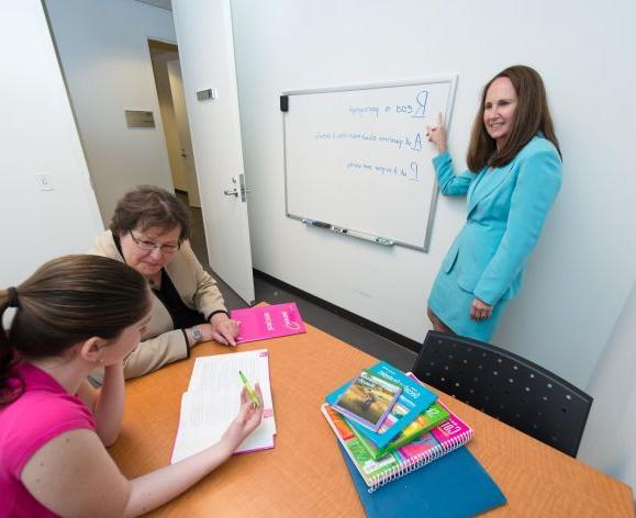 Professor Jeannene Ward-Lonergan and Associate Professor Jill Duthie, from the Department of Speech-Language Pathology and Audiology, work with a student in the Language-Literacy Center